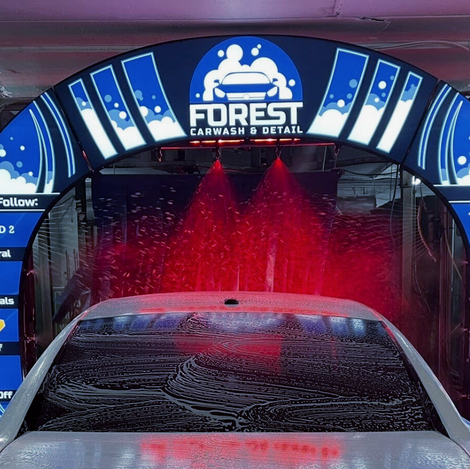 White car with suds in the car wash - Contact Forest Carwash & detail in dallas texas