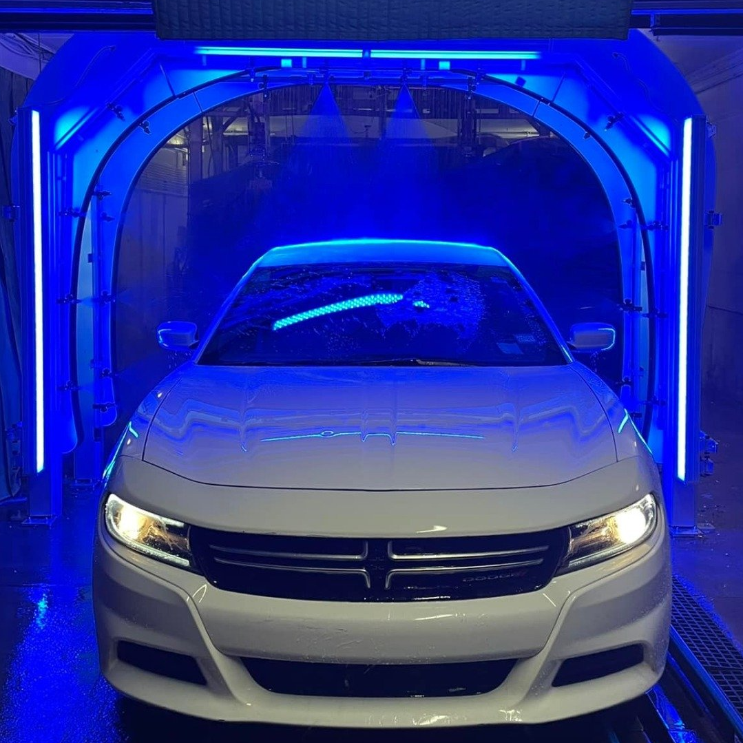 shiny white car in the car wash
