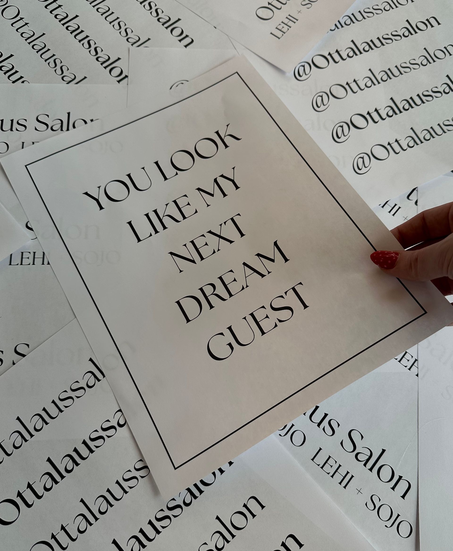 A hand holds a paper with the text
