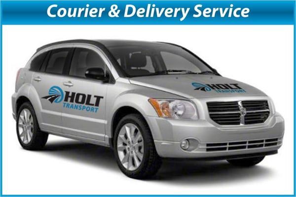 Silver courier car with Holt Transport logo and “Courier & Delivery Service” banner