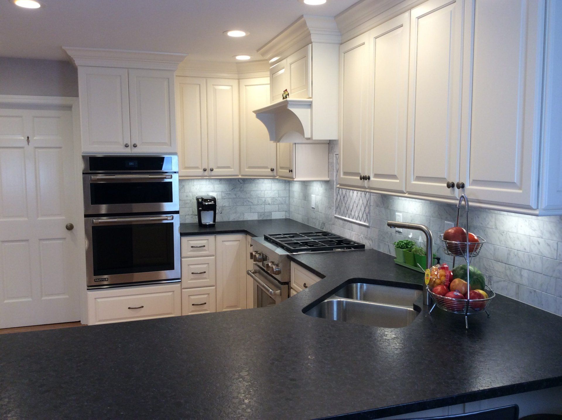 Modern kitchen with stylish cabinets that are painted the matching color scheme.