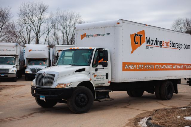 White moving truck with orange logo 