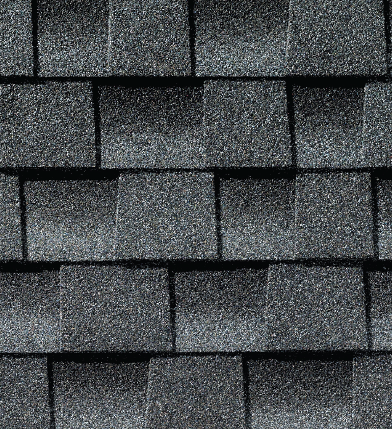 A close up of a row of gray shingles on a roof.