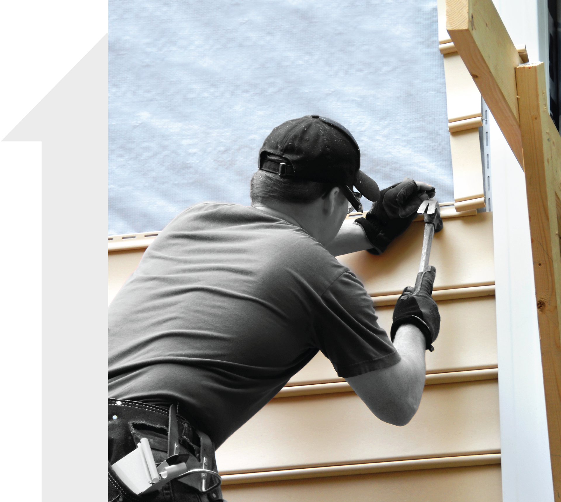 A black and white photo of a man working on a wall