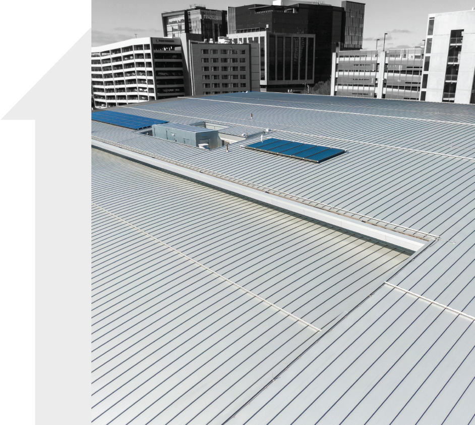 The roof of a building with a city in the background