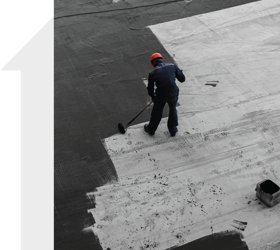 A man is painting a concrete surface with a roller