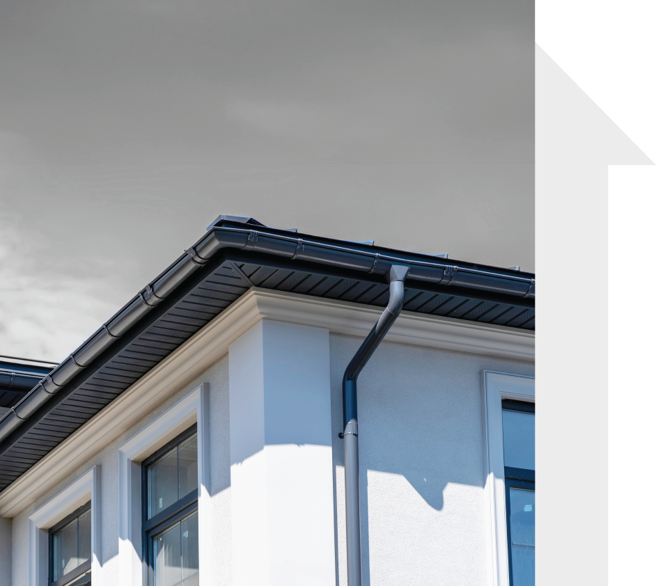 A white house with a black gutter on the roof