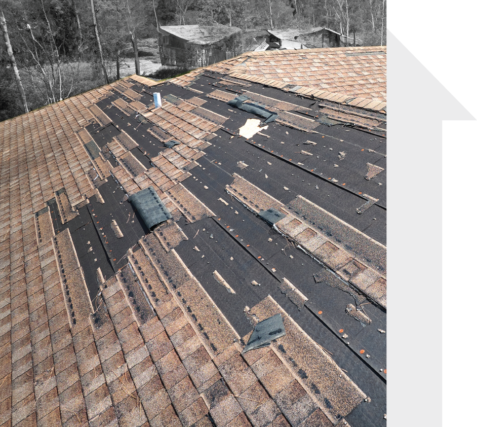 A black and white photo of a roof that is being repaired