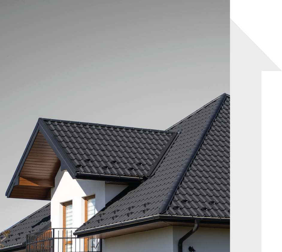 A house with a black tiled roof and a balcony