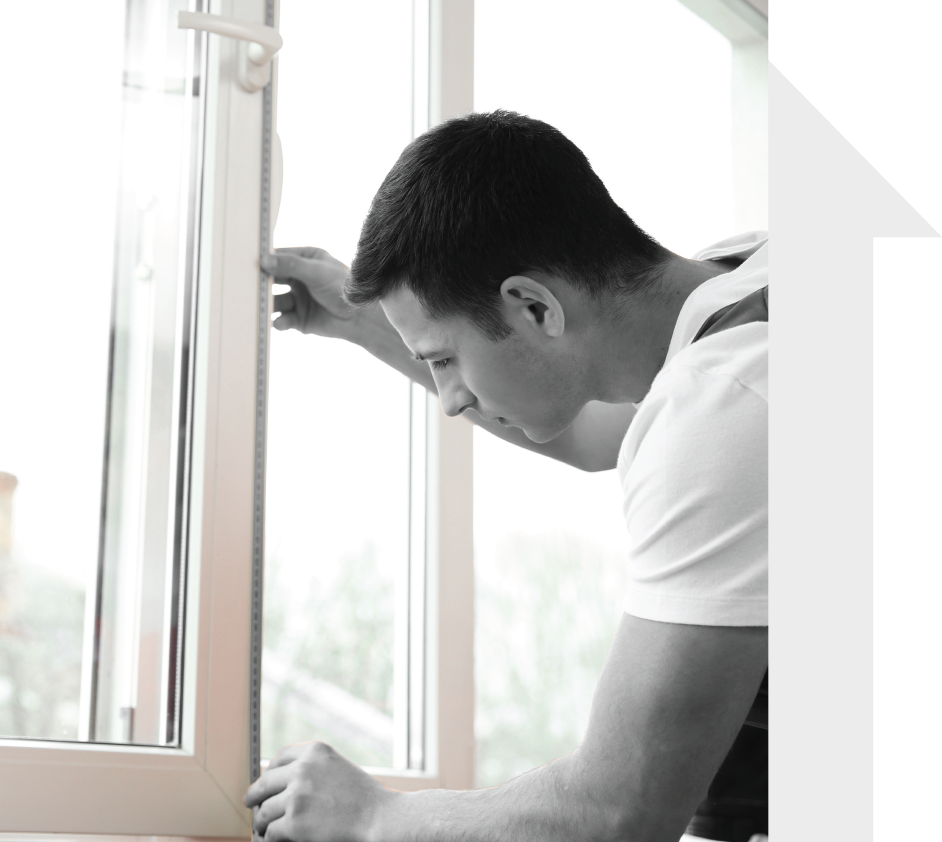 A man looking at his newly replaced windows.