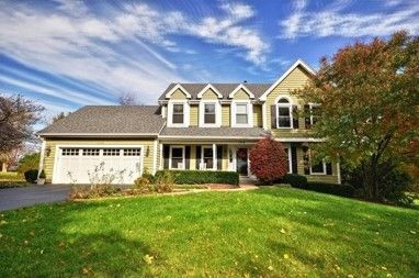 A large house with a large lawn in front of it