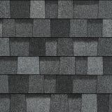 A close up of a row of gray shingles on a roof.