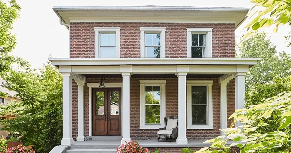 A brick house with newly replaced windows.