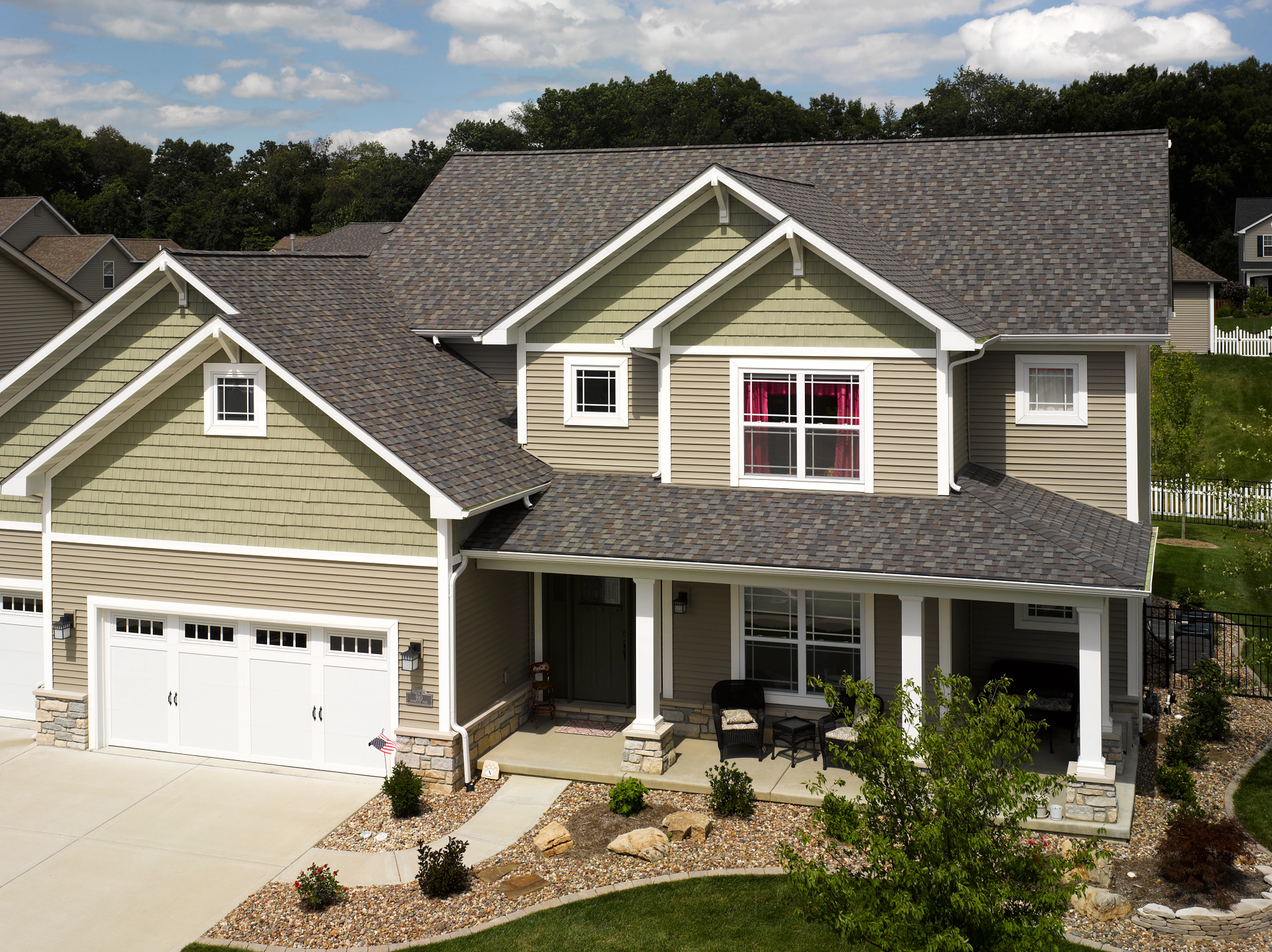An olive green house with a brown roof.