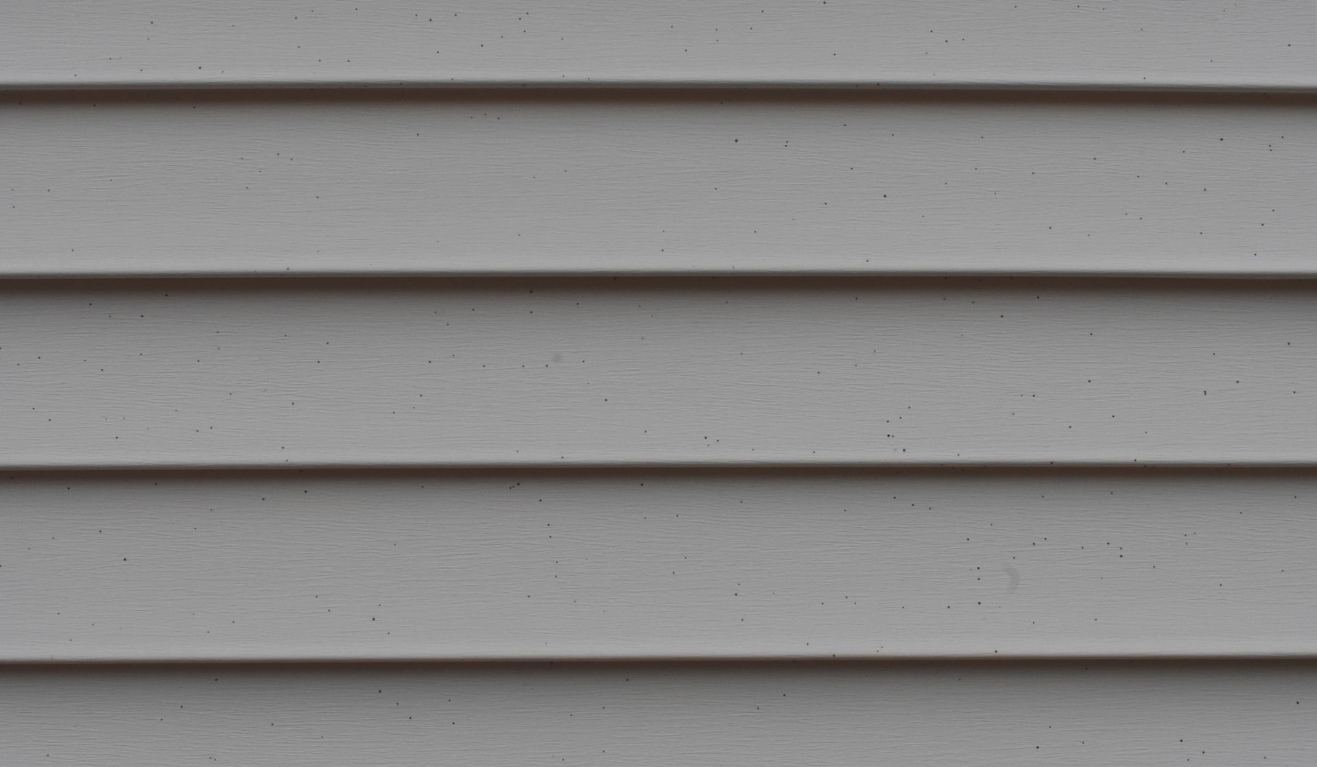 A close up of a gray siding on a house.