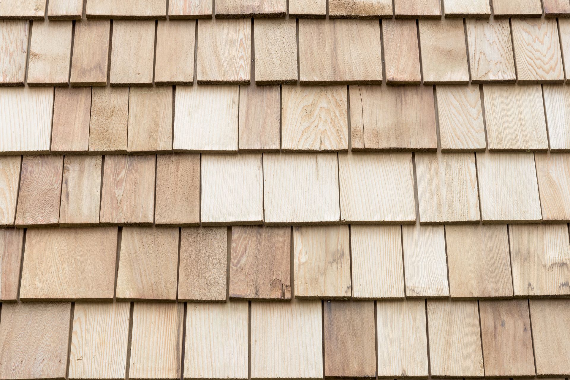 A close up of a wooden roof with wooden tiles.