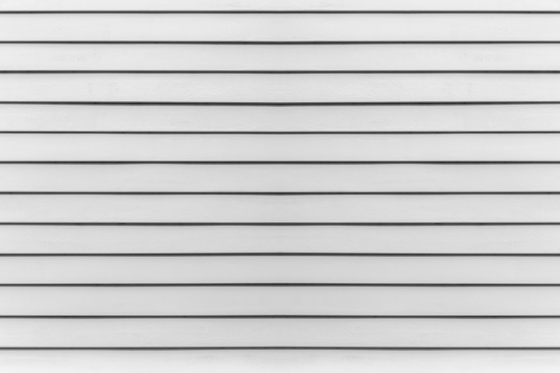 A close up of a white siding wall.
