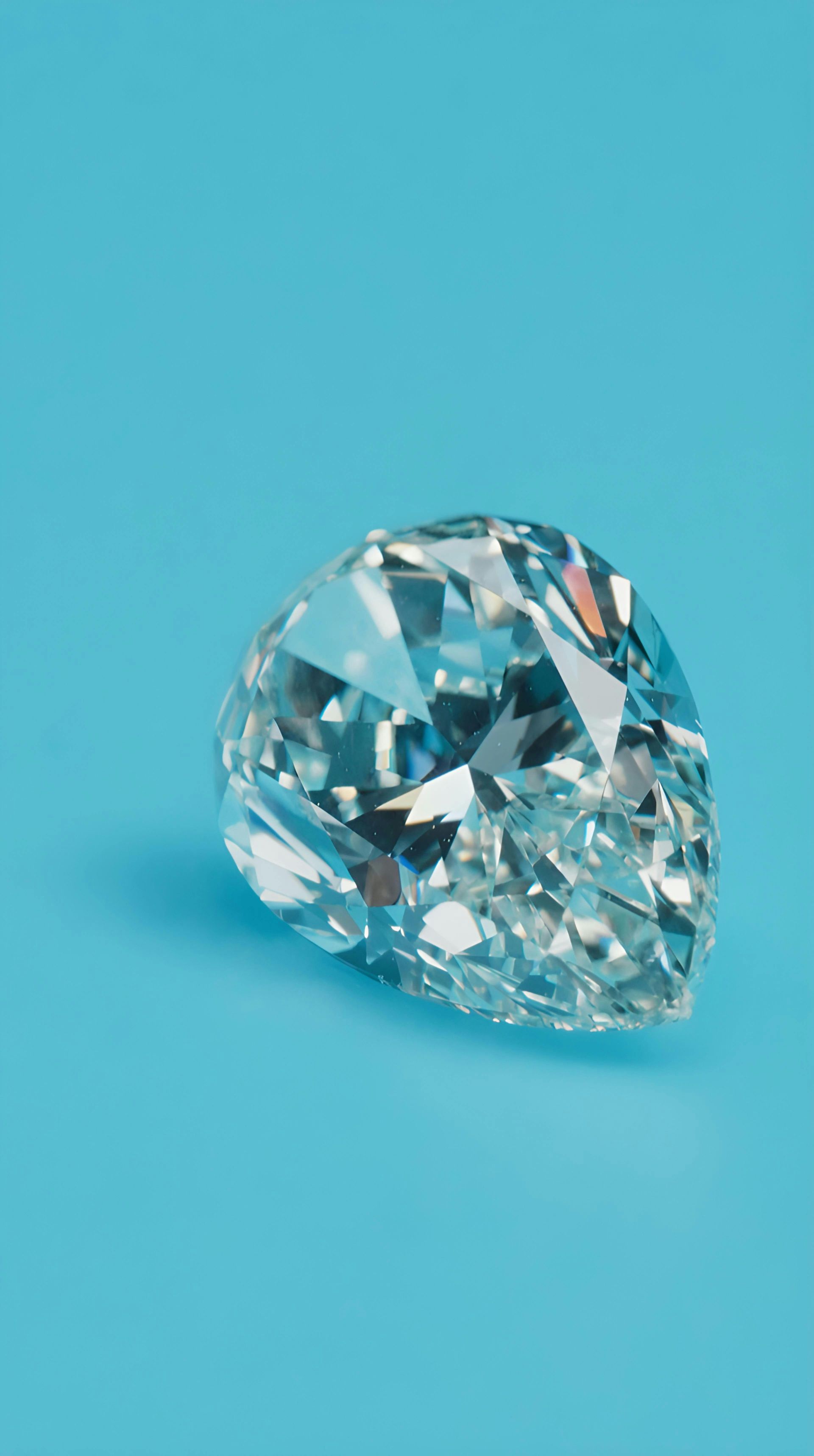 Clear faceted diamond on a bright blue background