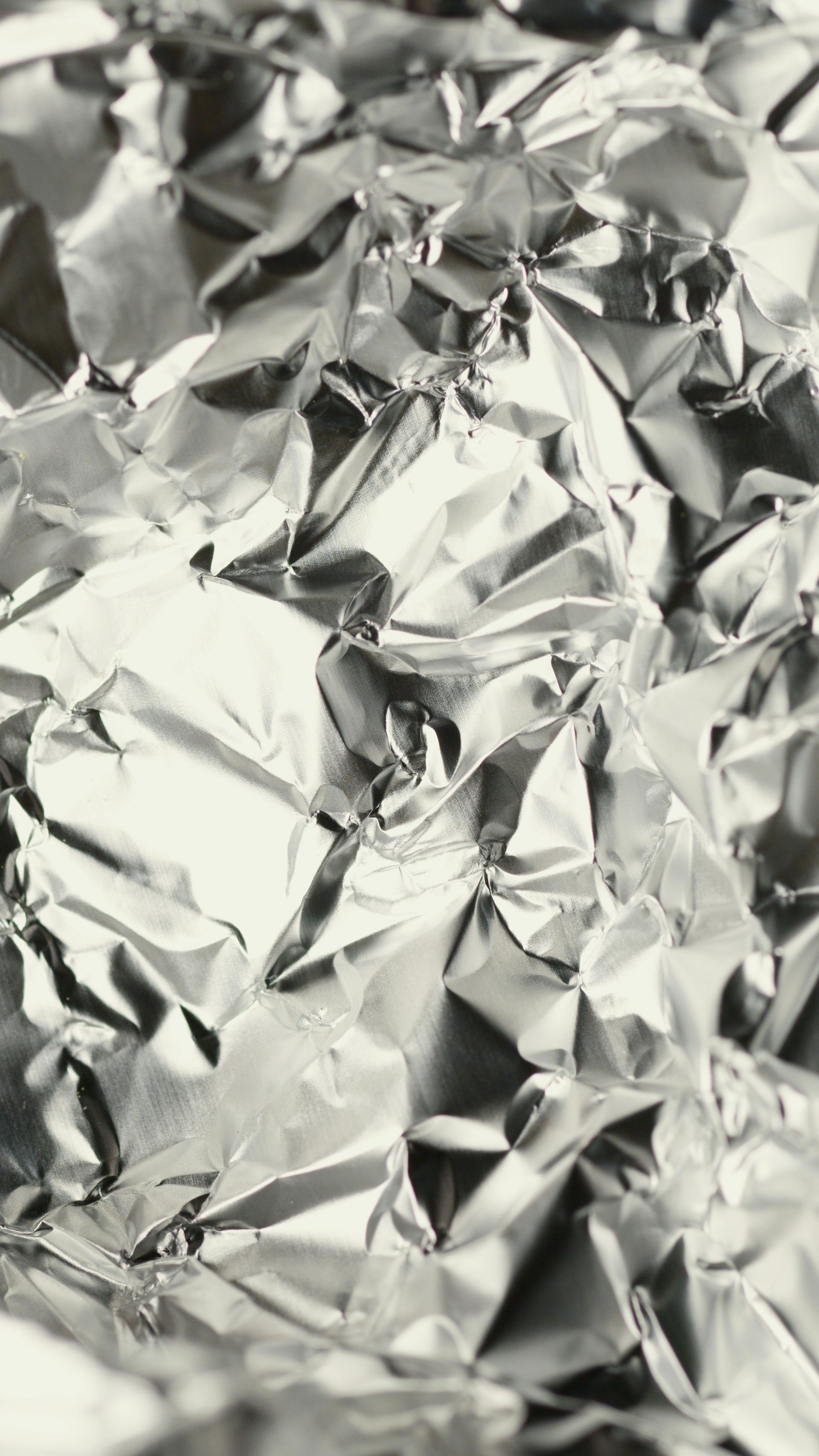 Crinkled silver aluminum foil filling the frame