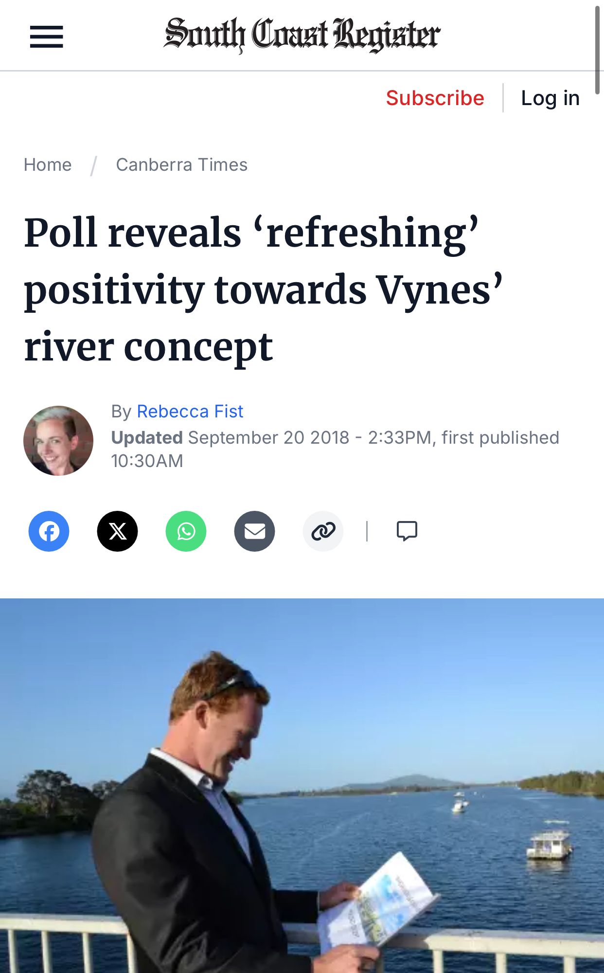 Article about river concept; man smiling, looking at plans near river.