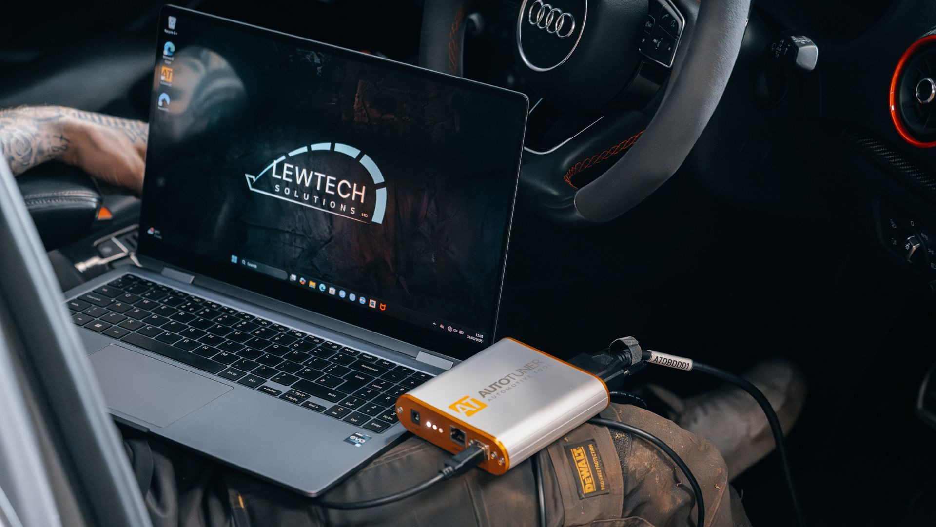 Vehicle module programming equipment connected inside a customer’s car