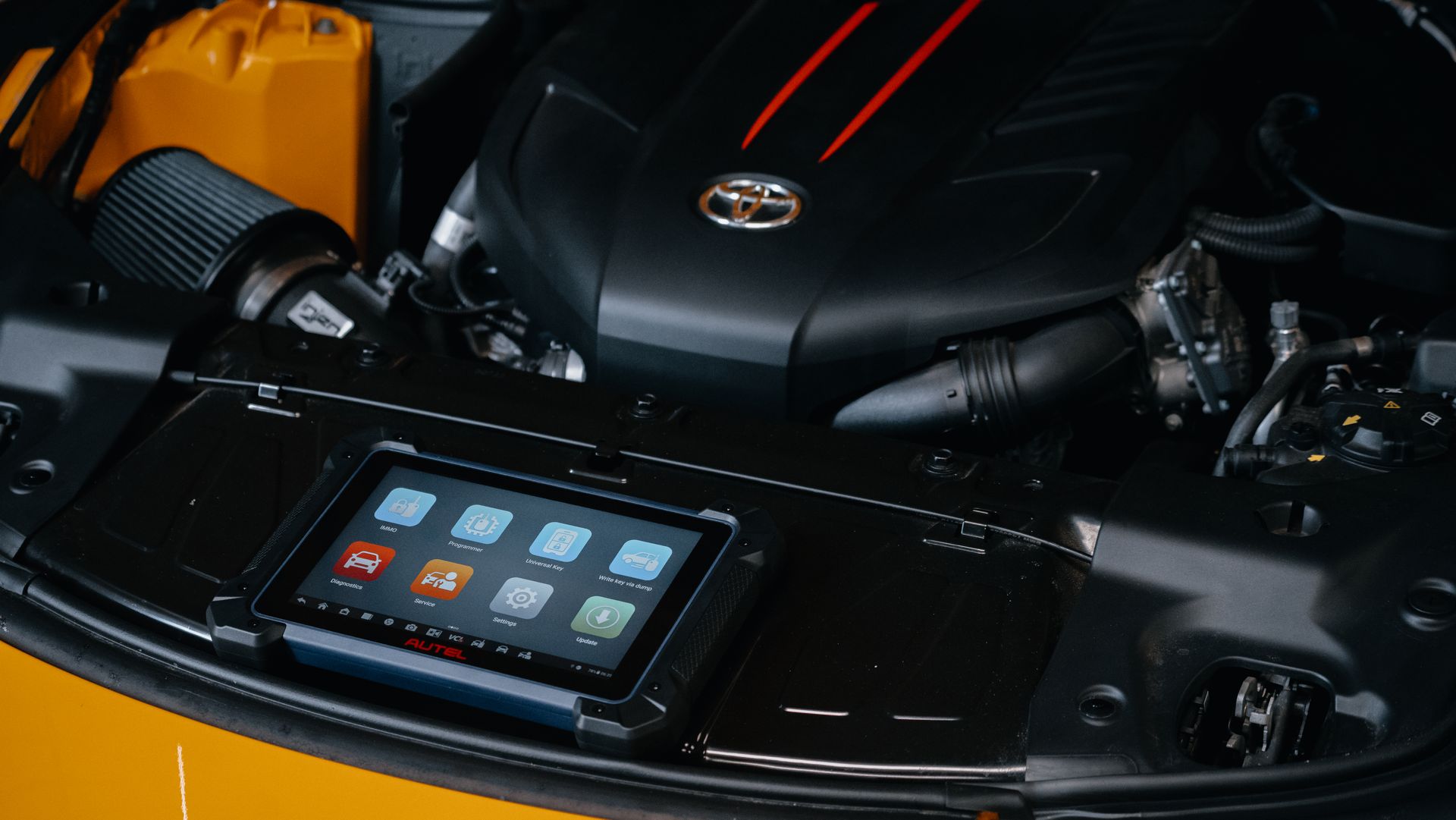 Professional vehicle diagnostic tablet being used inside a car