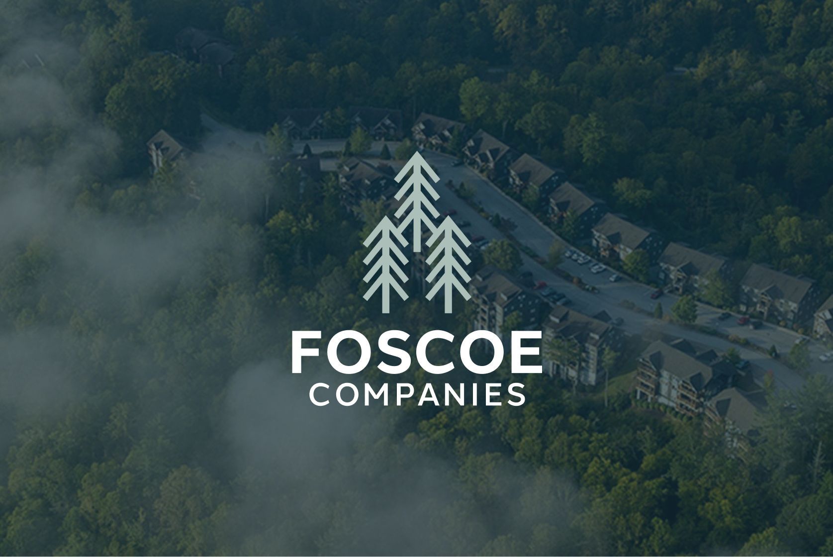 Foscoe Companies logo over a misty aerial view of forested homes in a mountain neighborhood