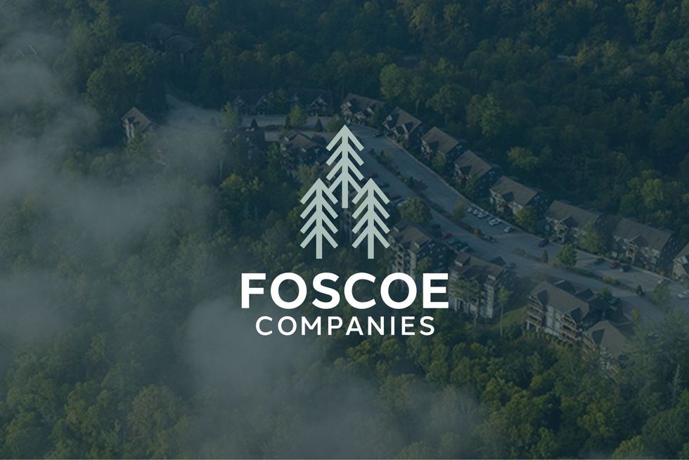 Foscoe Companies logo over a misty aerial view of forested homes in a mountain neighborhood