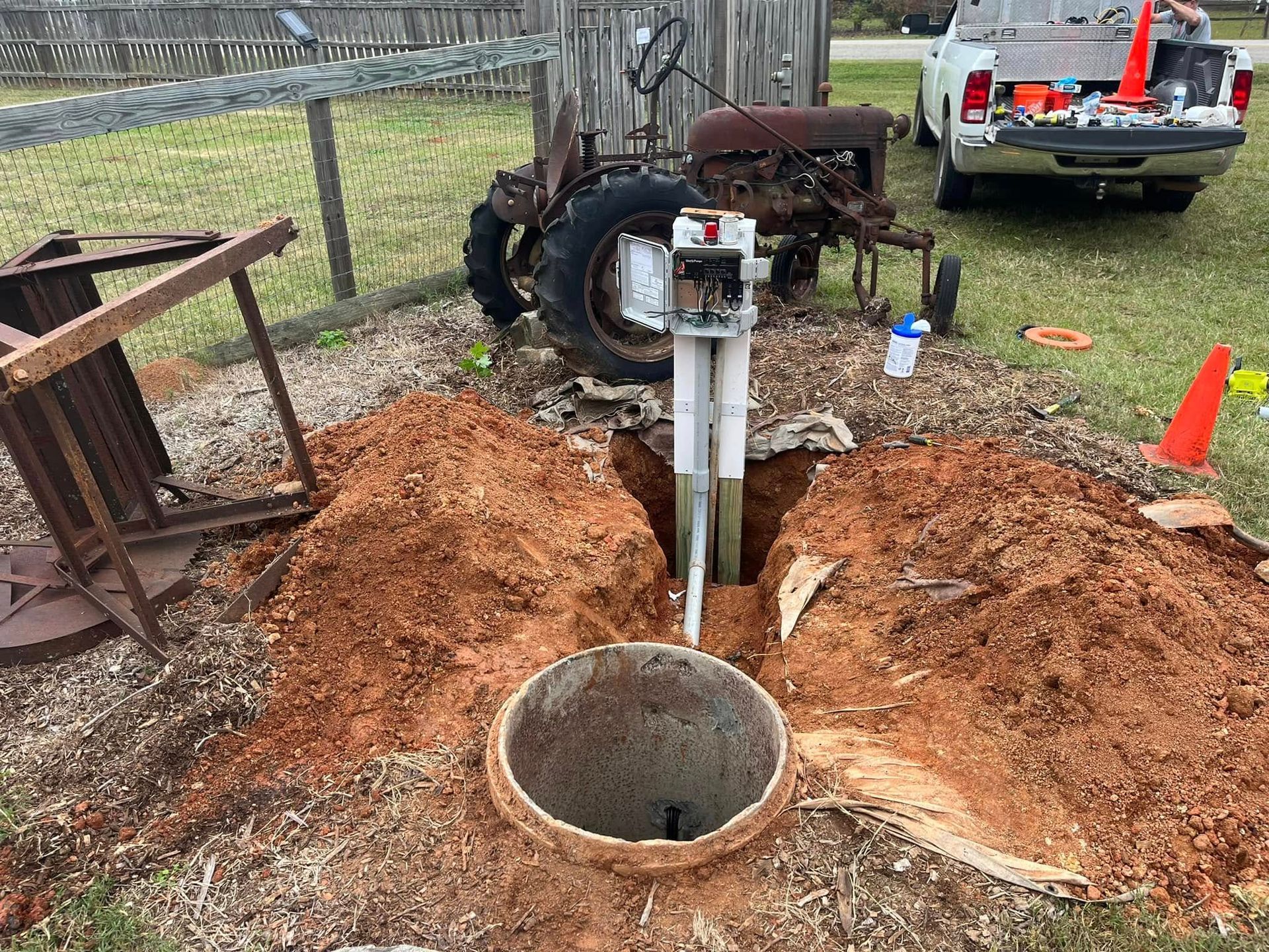 A truck is parked next to a hole in the ground.
