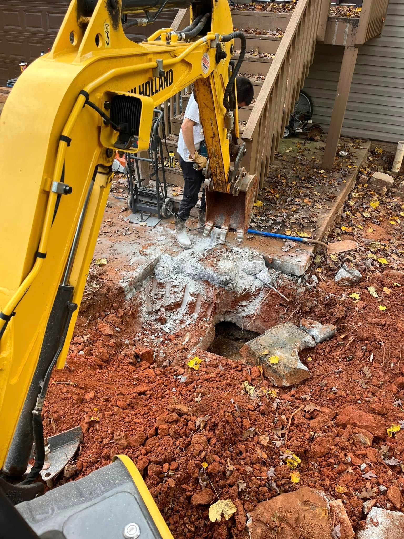 A large pile of dirt is in front of a house.