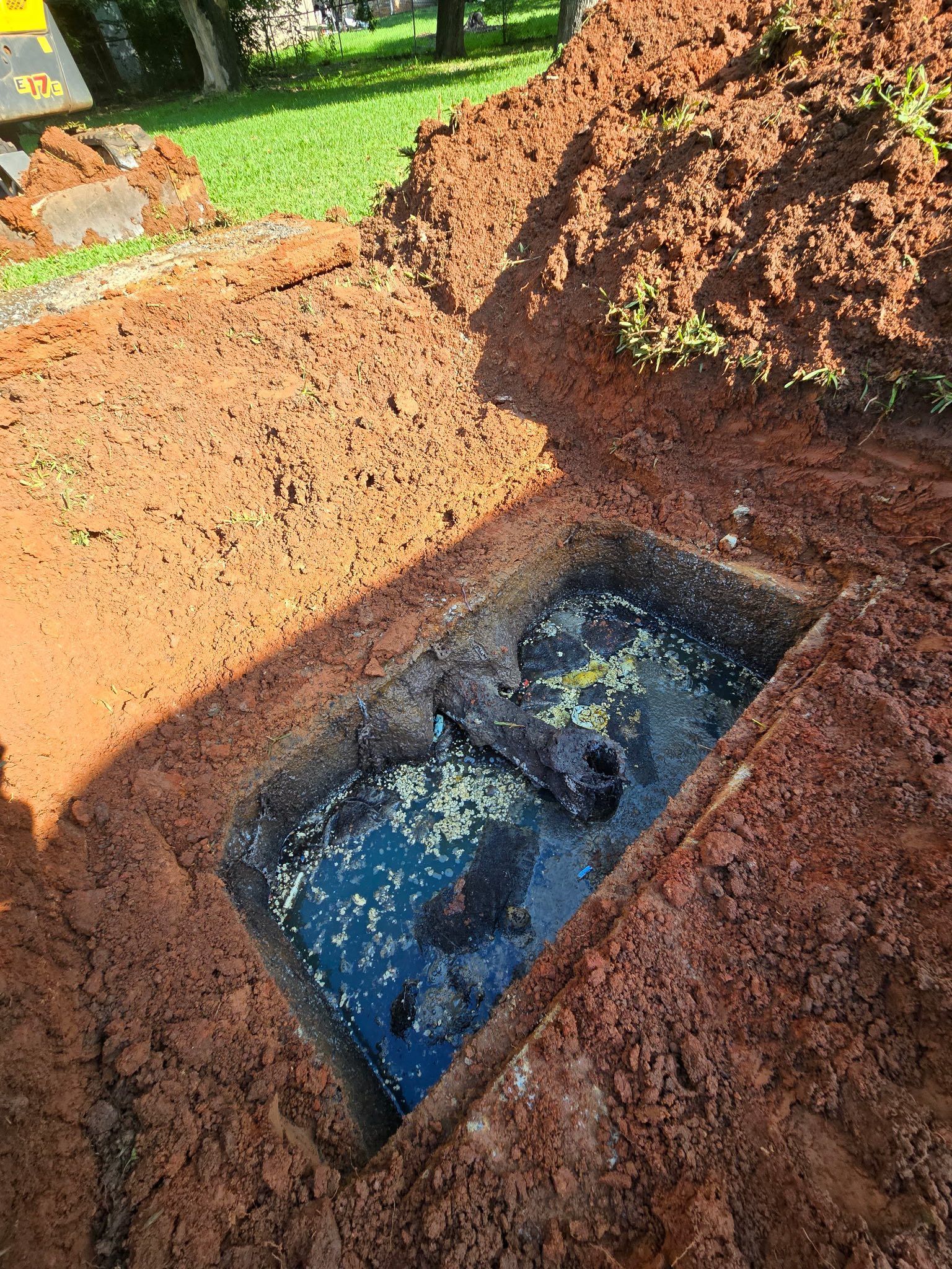 A truck is parked next to a hole in the ground.