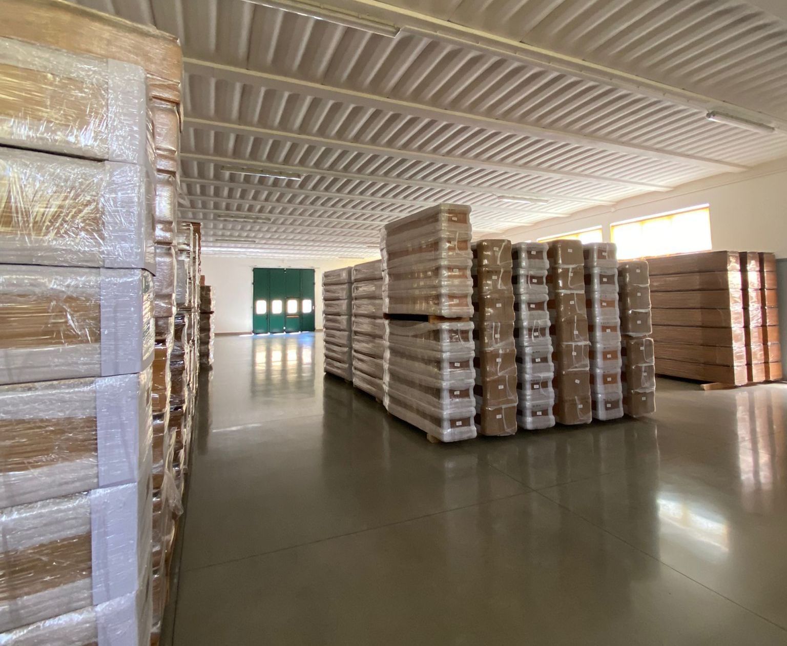 Un grande magazzino pieno di molti pallet di legno