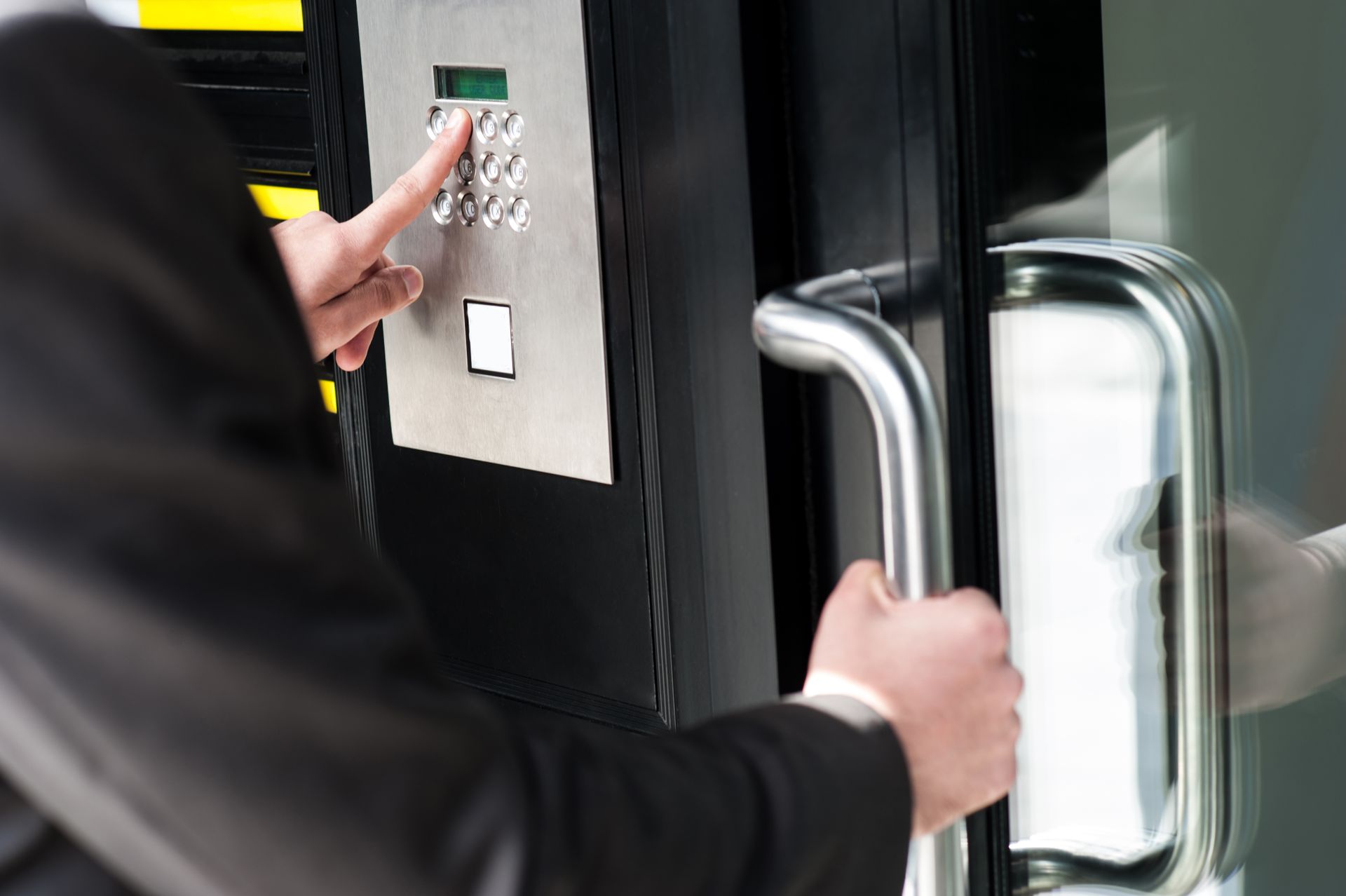 A man is using a keypad to open a door.