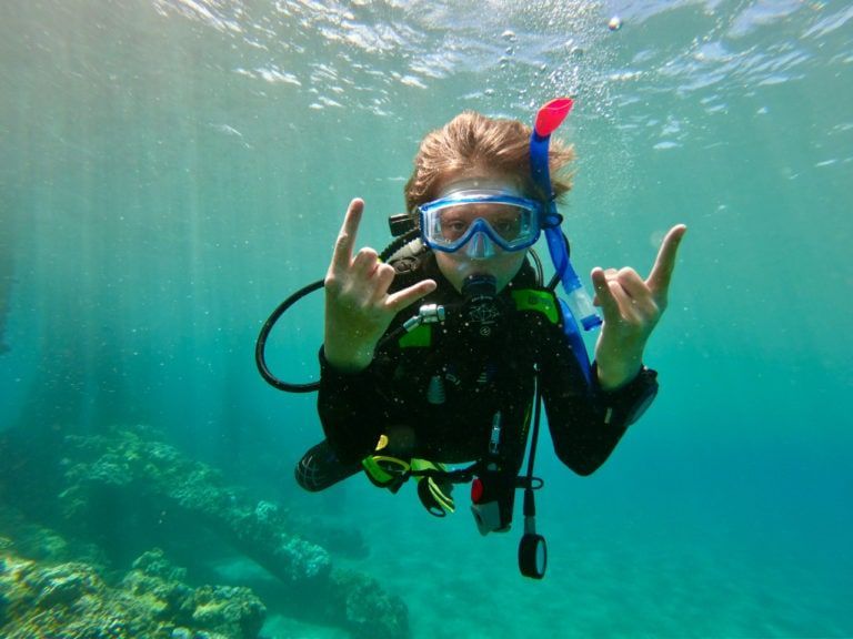 a scuba diver is giving the hang loose sign