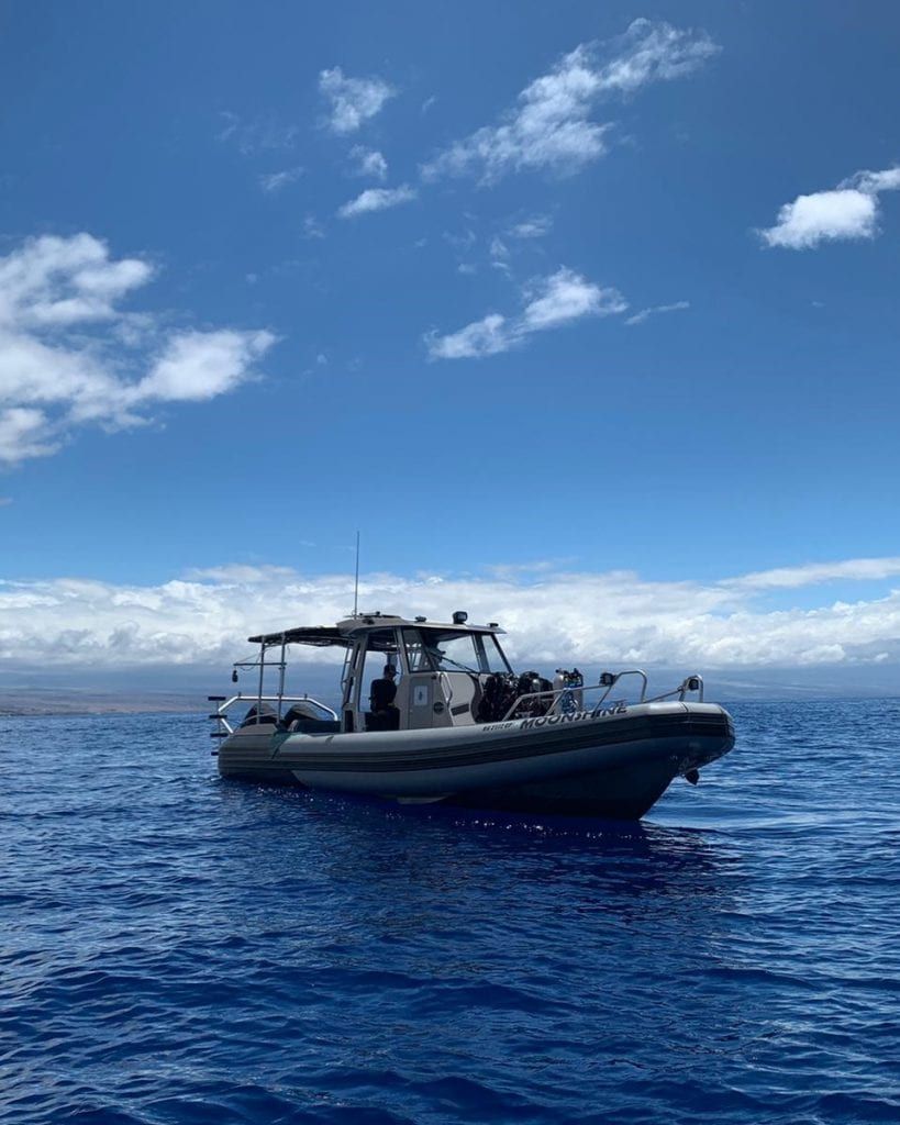 a boat with the name Moonshine on the side of it