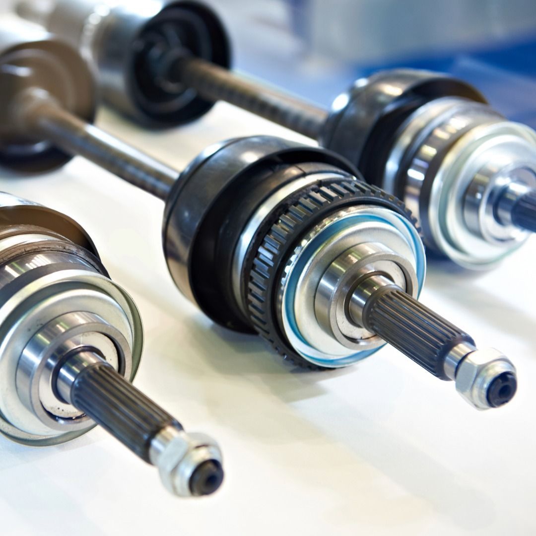 Close-up of shiny metal dumbbells arranged on a rack, with black and silver grips