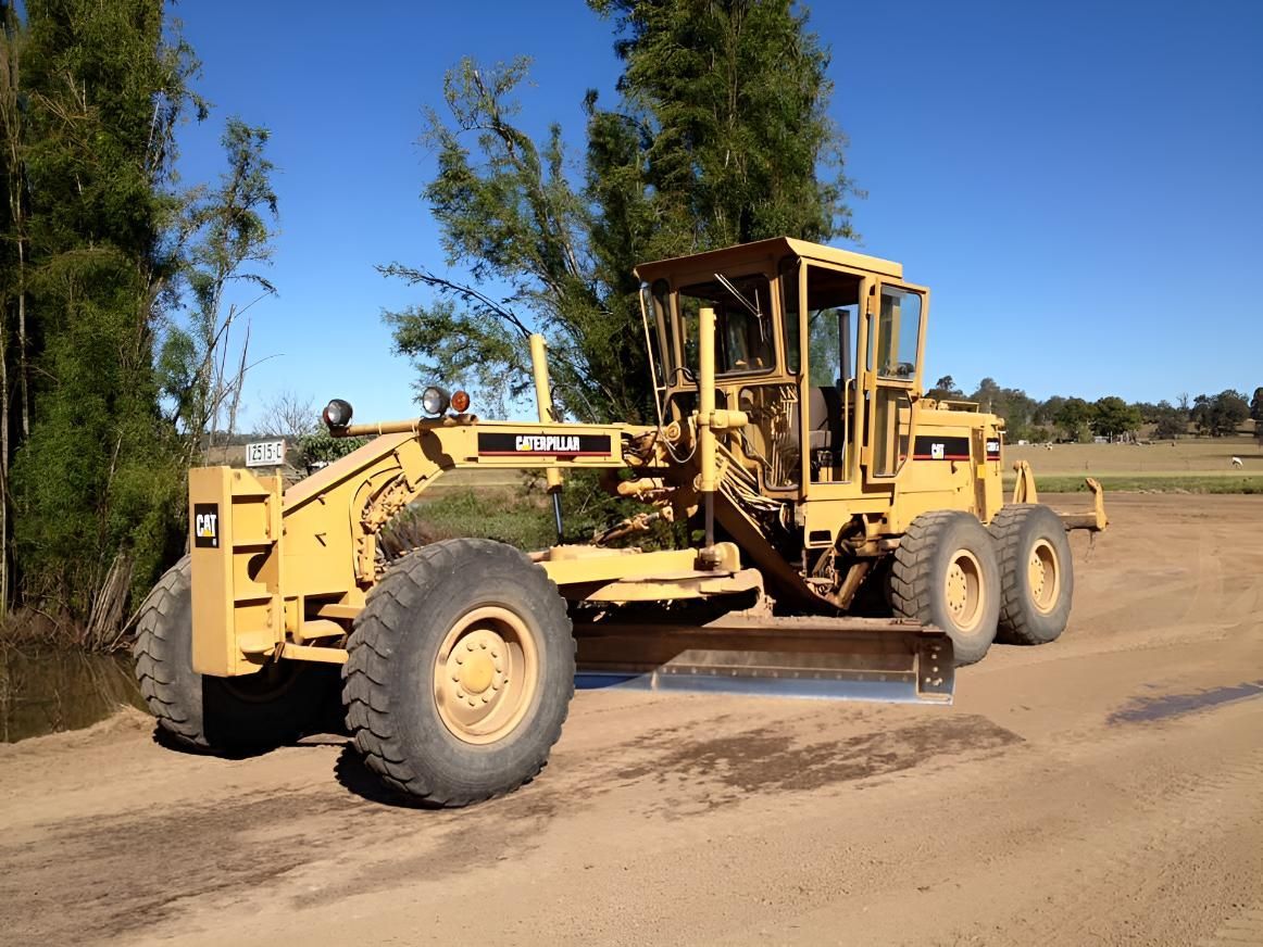 A Yellow Bulldozer Is Parked On A Dirt Road — BB & F Constructions Pty Ltd In Taree, NSW