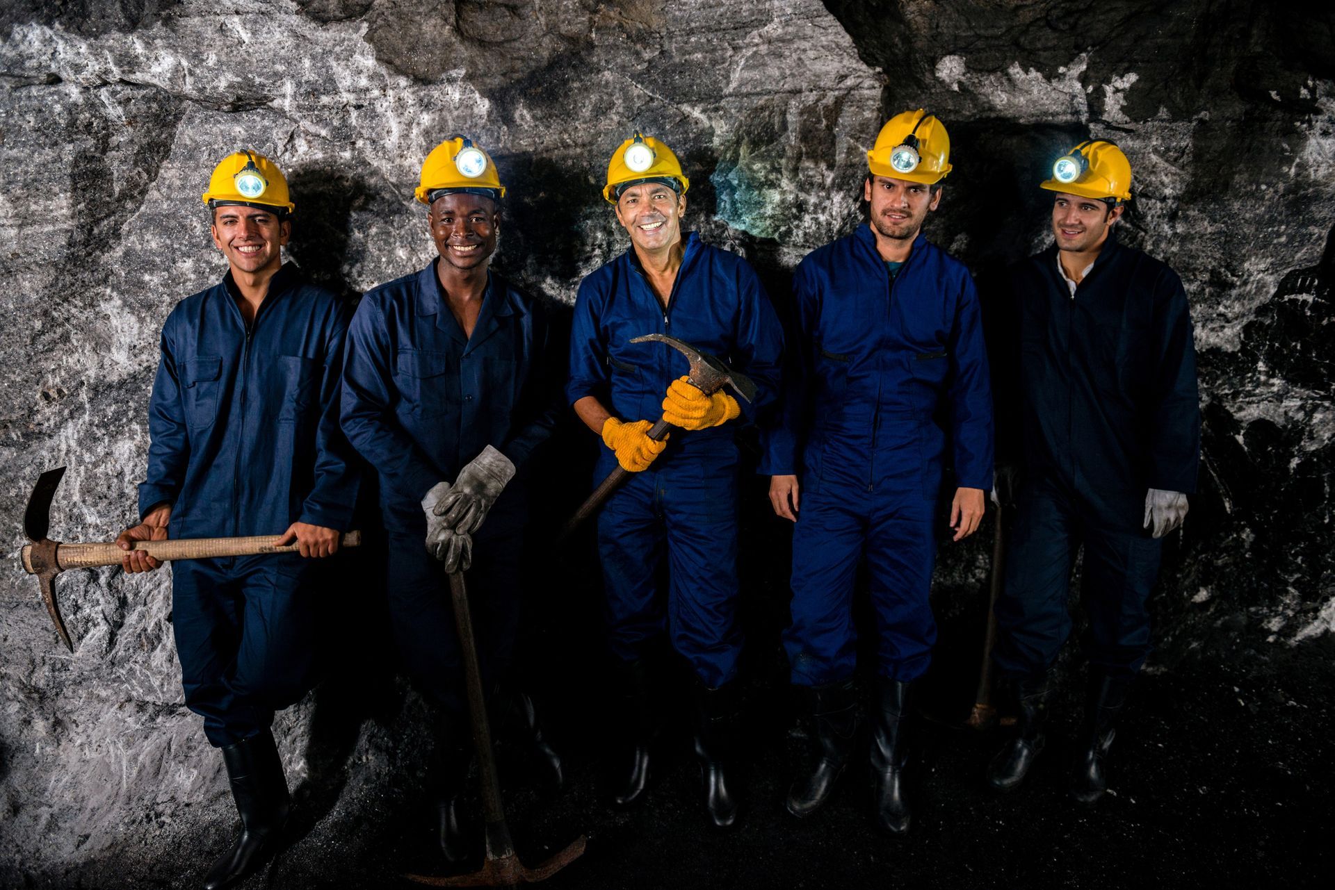 A group of miners are posing for a picture in a cave