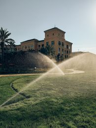 Irrigation rotors spraying on a campus.