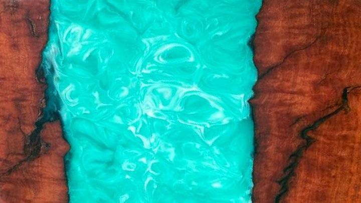 Wood slab table with turquoise epoxy river.