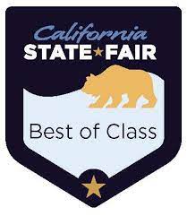 A california state fair best of class badge with a bear on it.