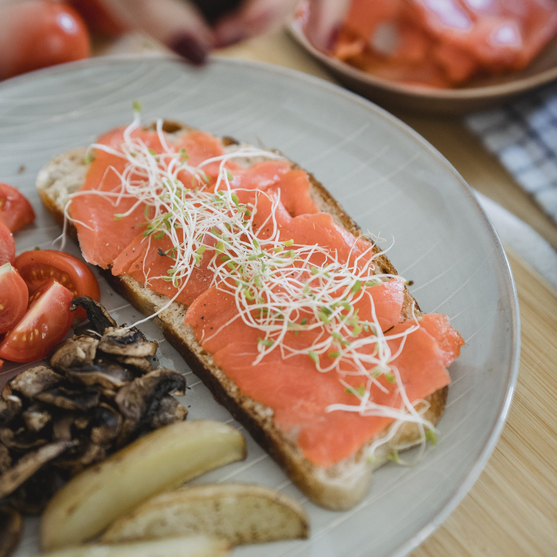 A close up of a plate of food with tomatoes and mushrooms