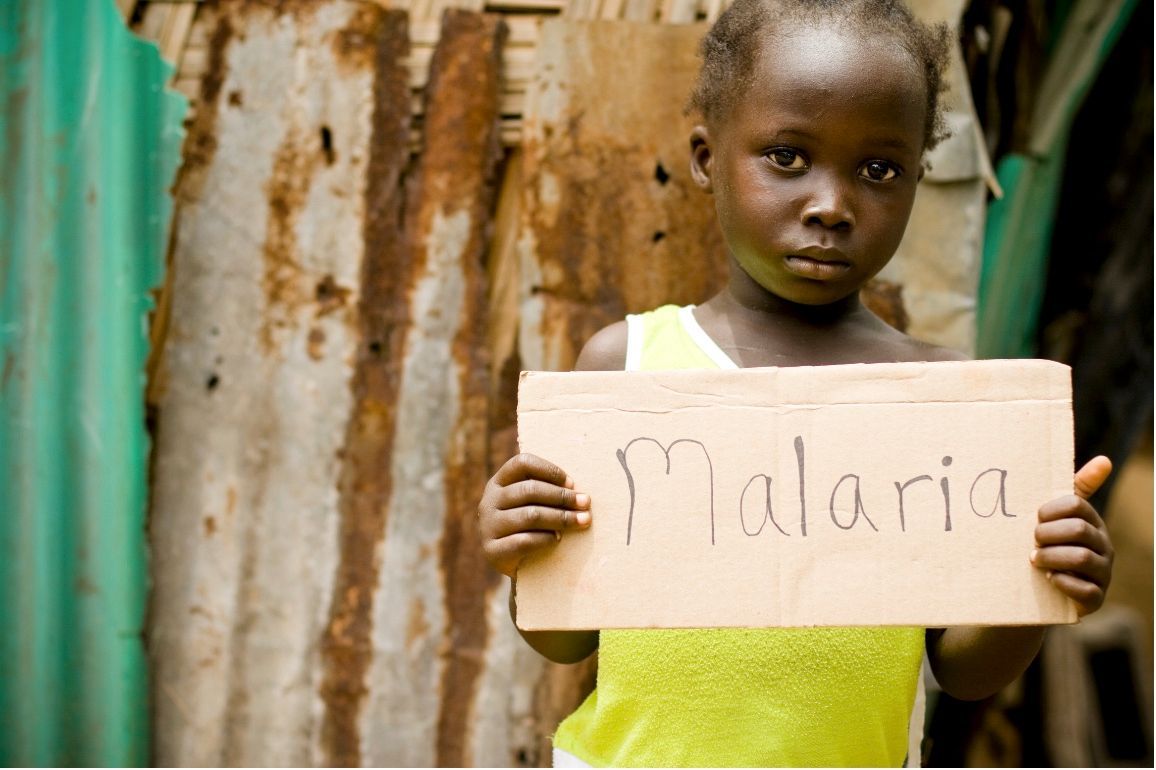 Child holding a sign that reads 