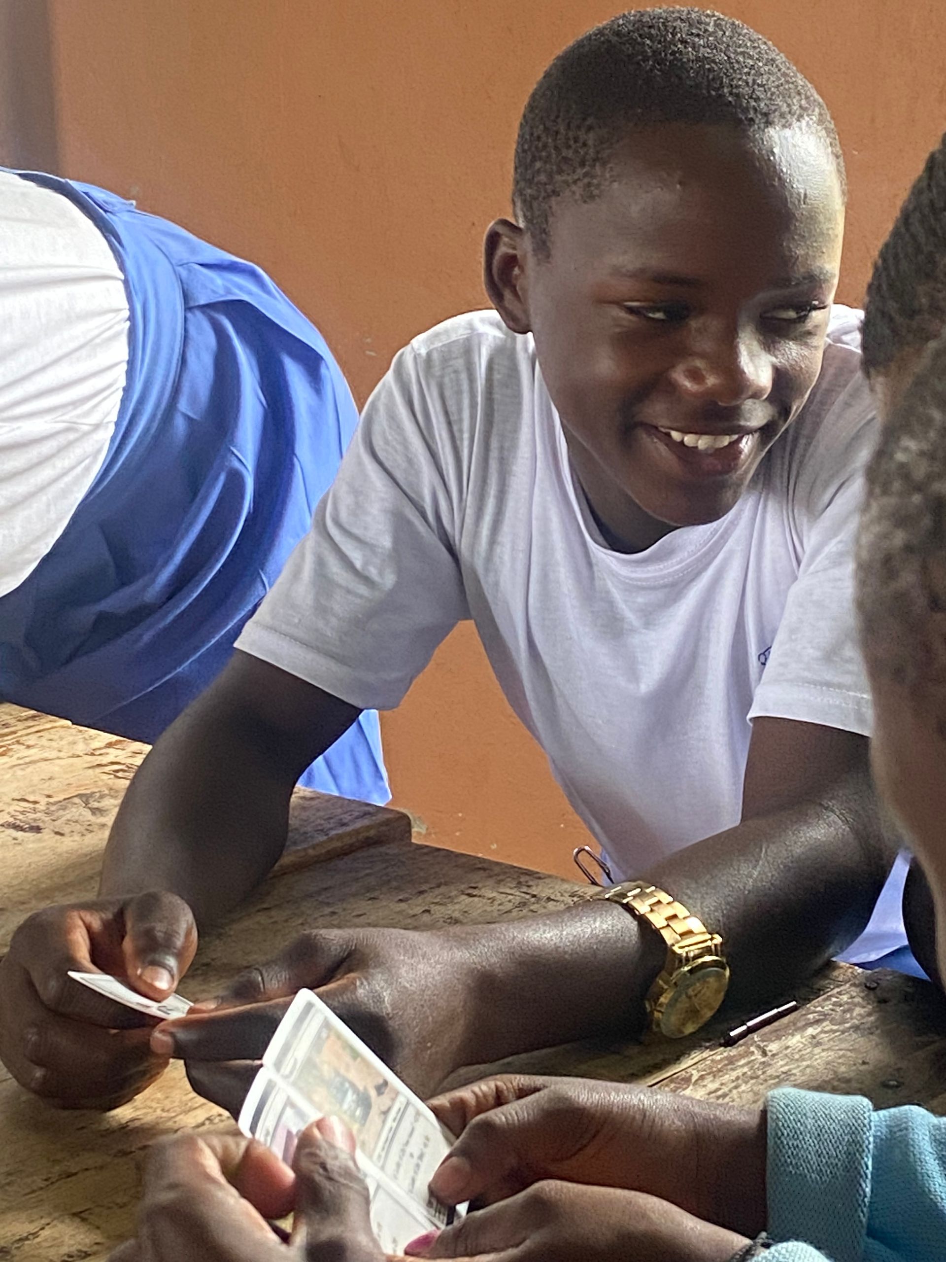 happy boy holding playing card