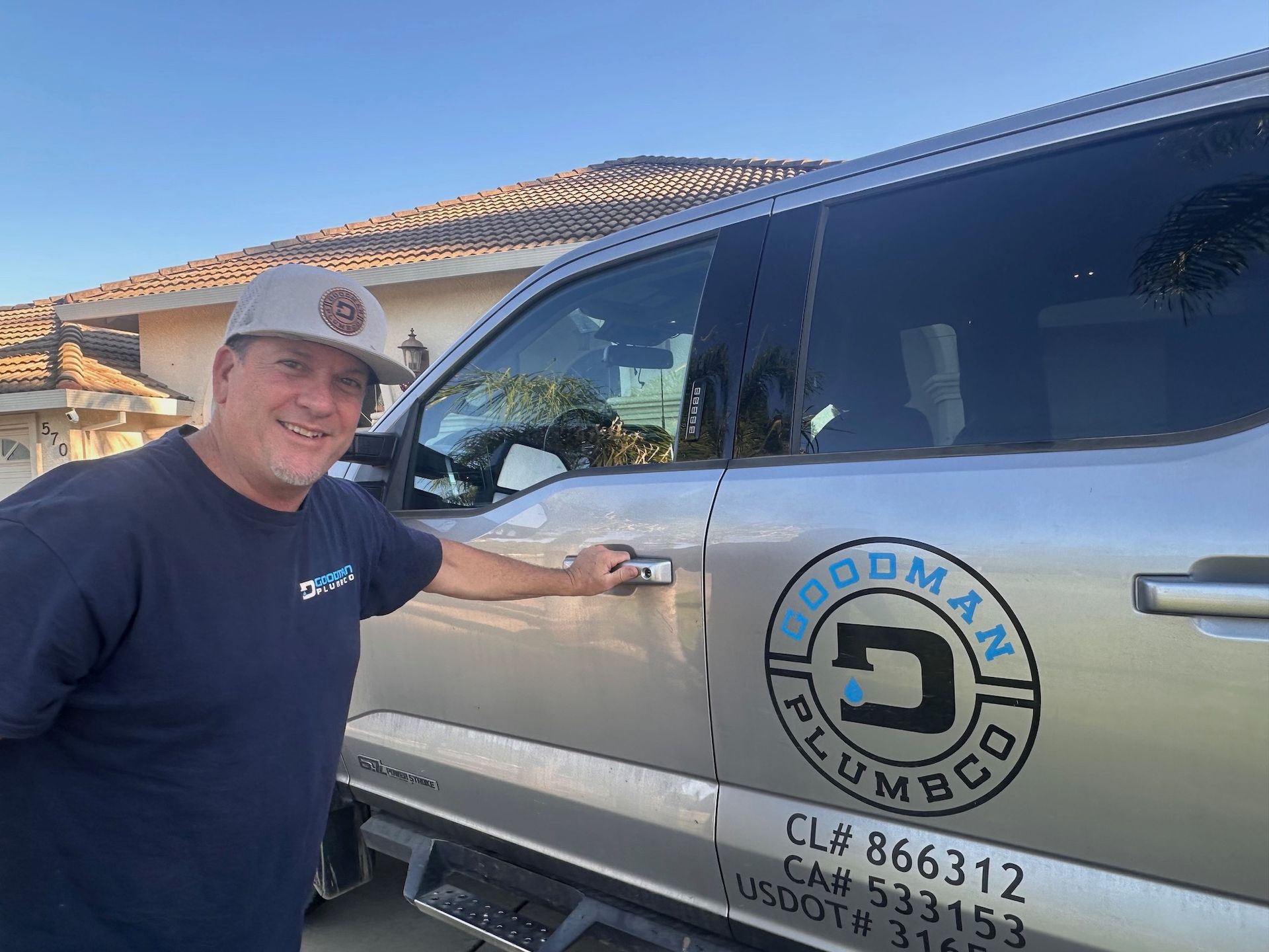 Man in cap by a truck with 