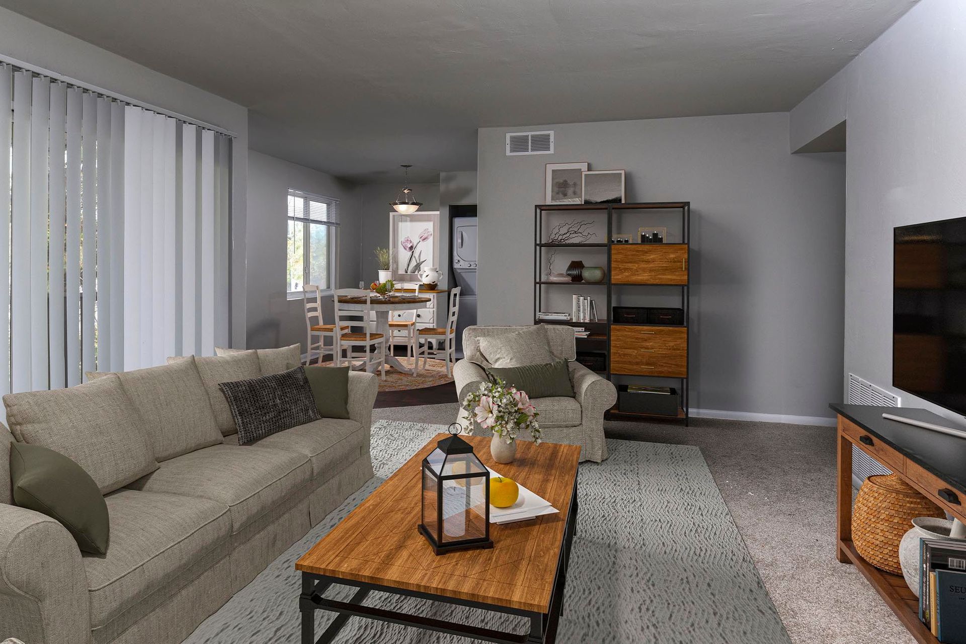Living room in an apartment with a beige sofa, chairs, and a wooden coffee table at Chesapeake Pointe, offers Chesapeake, VA apartments for rent.