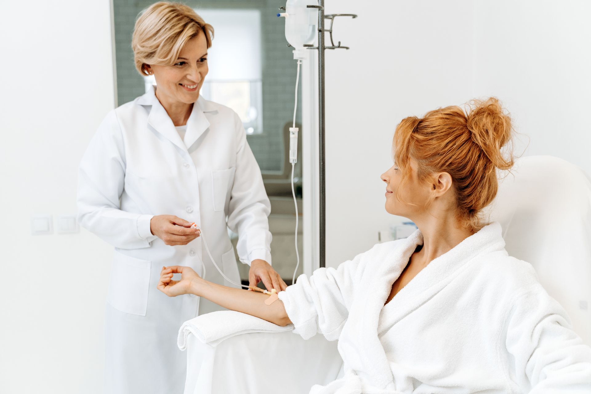 Doctor taking a blood sample from a patient in a bright clinic room