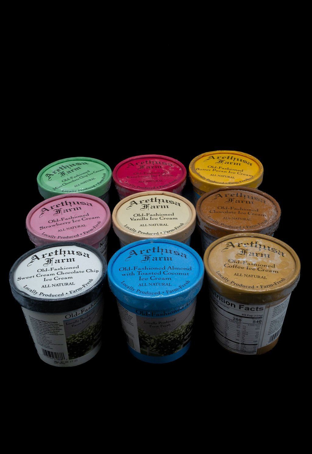 Nine colorful tubs of Arethusa Farm ice cream arranged in a 3x3 grid against a black background.
