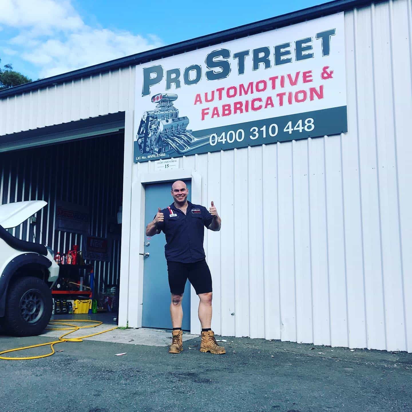 A Man Is Standing In Front Of The Shop — ProStreet Automotive & Fabrication In Cardiff, NSW