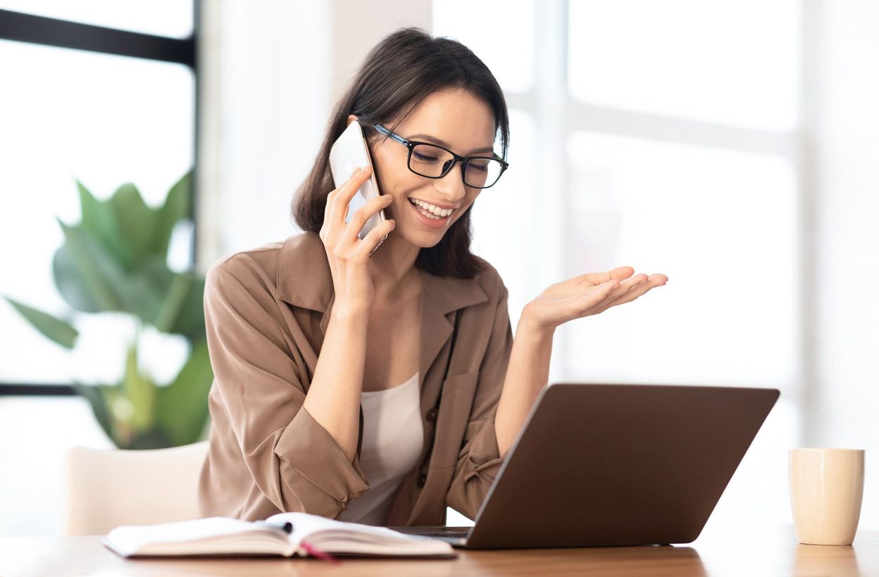 freelancer using laptop computer while calling